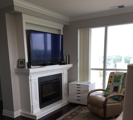 living room with tv over fireplace